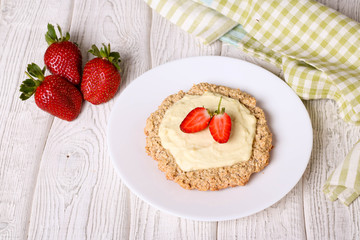 Fresh baked curd tarts with strawberries