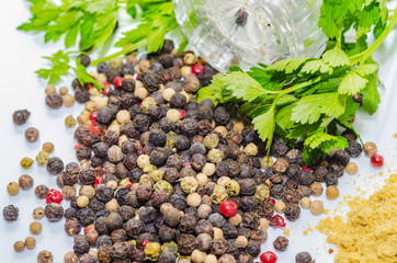 Fragrant black pepper on a white background, this is a common spice with useful properties obtained from seeds of plants of the genus Pepper