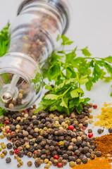 Fragrant black pepper on a white background, this is a common spice with useful properties obtained from seeds of plants of the genus Pepper