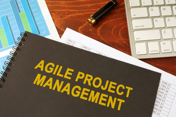Book with title agile project management in an office.