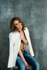 Fototapeta premium Young laughing woman in lace lingerie and white jacket
