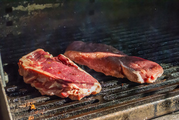 bbq beef steaks on hot grill