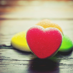 Fototapeta premium Heart candies coated with sugar, heart colorful sweet candies, sugar heart shaped candy