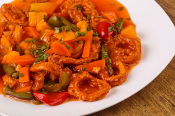 Squid rings in sweet and sour sauce with vegetables