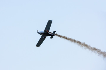 A small sports plane is burning in the air