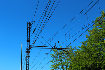 Modern railway wires against blue sky