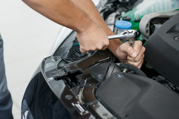 Professional car mechanic repairing a car