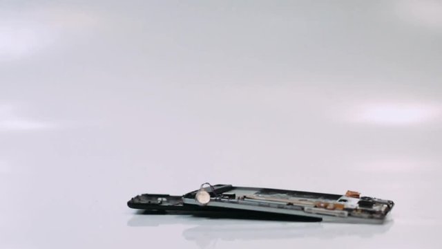 Destruction of the smartphone, the phone falls to the surface in slow motion. 
