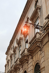 Fototapeta premium Old street lamp in Lisbon, detail of an old lighting in the city.
