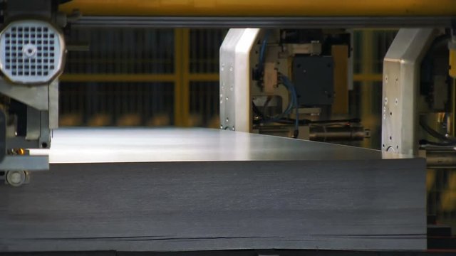 stowage of cutted metal sheets on a Car production, robotic production of detail for cars