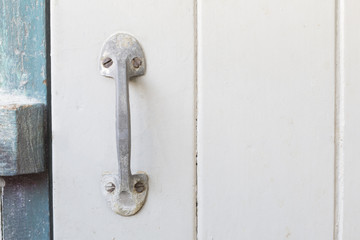 Old steel handle on wooden door with copyspace.
