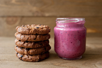 Cookies on rustic wooden  table. Chocolate dessert with berry fresh smoothie.