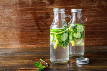 Light, refreshing drink of lime, lemon and cucumber in small glass bottles