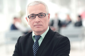 Fototapeta premium Portrait of mature businessman with colleagues interacting on b