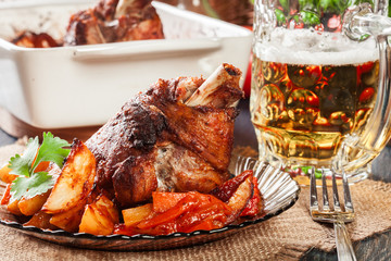 Roasted turkey knuckle with potatoes and vegetable