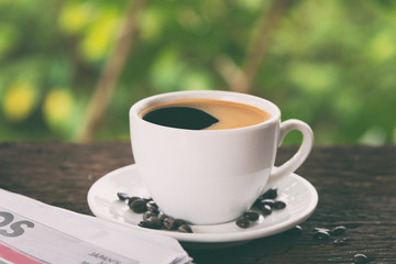 A cup of coffee and a newspaper