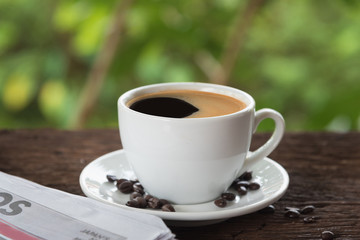 A cup of coffee and a newspaper