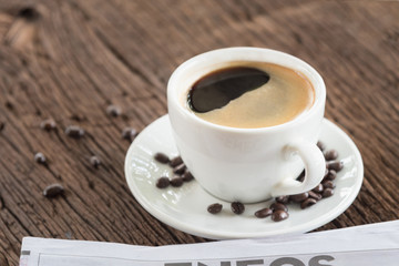 A cup of coffee and a newspaper