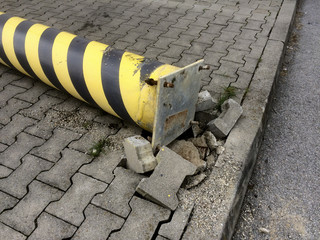 schwarz gelbe Absperrung aus dem Boden gerissen