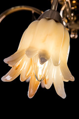 Chandelier light in interior closeup on black background