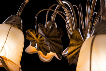 Chandelier light in interior closeup on black background