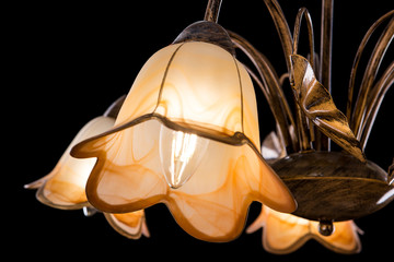 Chandelier light in interior closeup on black background