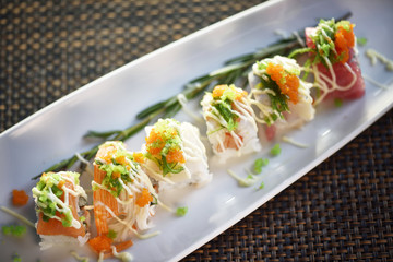 Top View Sushi Roll with Crab Stick On White Plate , Japanese food style ,selective focus.