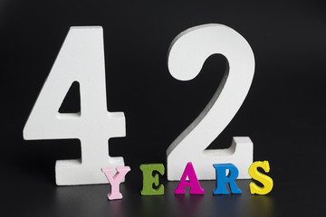 Letters and numbers forty-two on a black background.