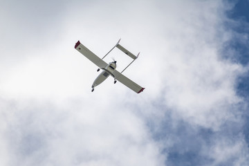 Unmanned aerial vehicle (UAV) in blue sky.