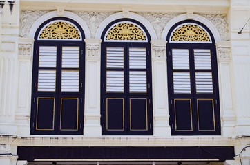 Old Vintage Windows on Cement Wall with Sino-Portuguese Architecture Style at Phuket Island, Thailand.