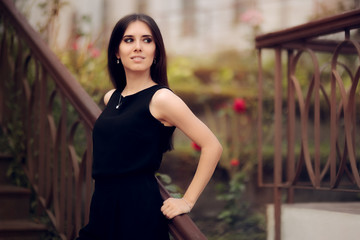 Elegant Woman Wearing Black Dress Standing in a Patio