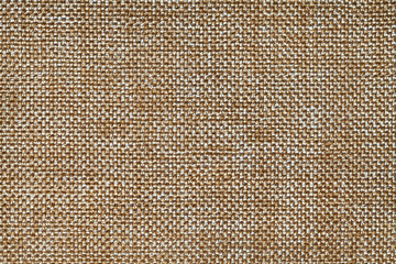 Ocher textile background closeup. Structure of the fabric macro