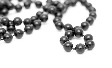 Black beads on a white background