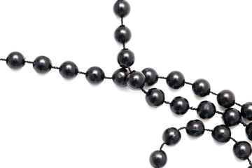 Black beads on a white background