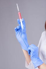 Nurse holding a syringe in his hand