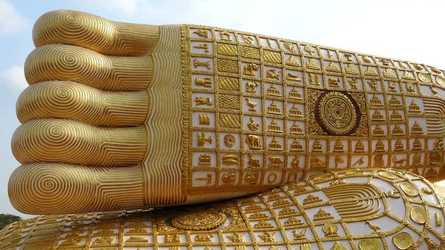 Footprint of Golden Buddha in Wat Phra That Suthon Mongkon Kiri temple in Den Chai, Thailand.