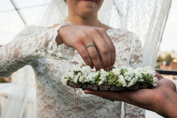 Obraz na płótnie Canvas Wedding day. The groom places the ring on the bride's hand. Photo closeup
