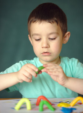 Boy playing with color play dough