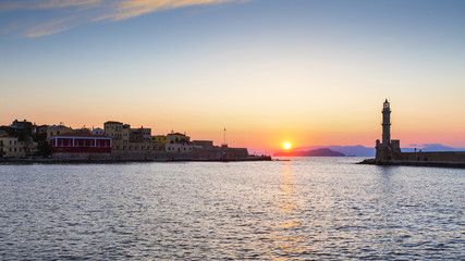 Fototapeta premium Lighthouse in the mouth of the old Venetian harbor of Chania town in Crete , Greece. 