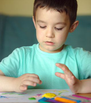 Boy playing with color play dough