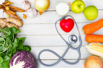 Healthy food and red heart and cholesterol diet concept on vintage boards