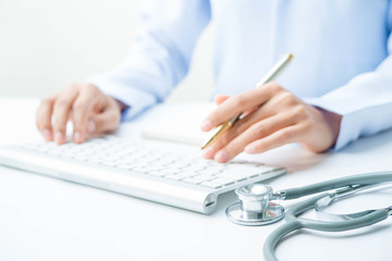 Docter and stethoscope on white table