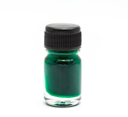 Bottle with green liquid medicine on white background.