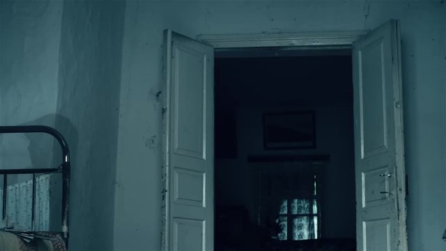 Horror Scene of a scary girl in room. The ghost walks around the room