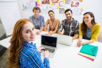 Executive discussing over laptop