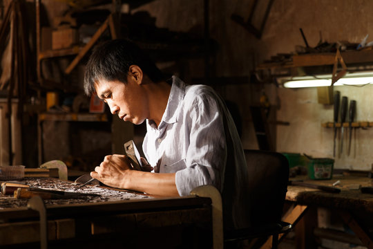Man engraving in workshop