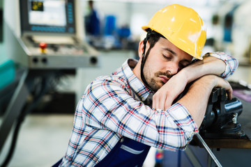 Tired worker fall asleep during working hours in factory