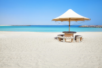 Beautiful beach with sun umbrella, summer holidays concept, copy space.