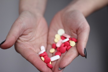 Colorful pills in women's hands
