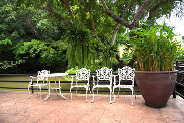 Relax corner in garden with white chairs
